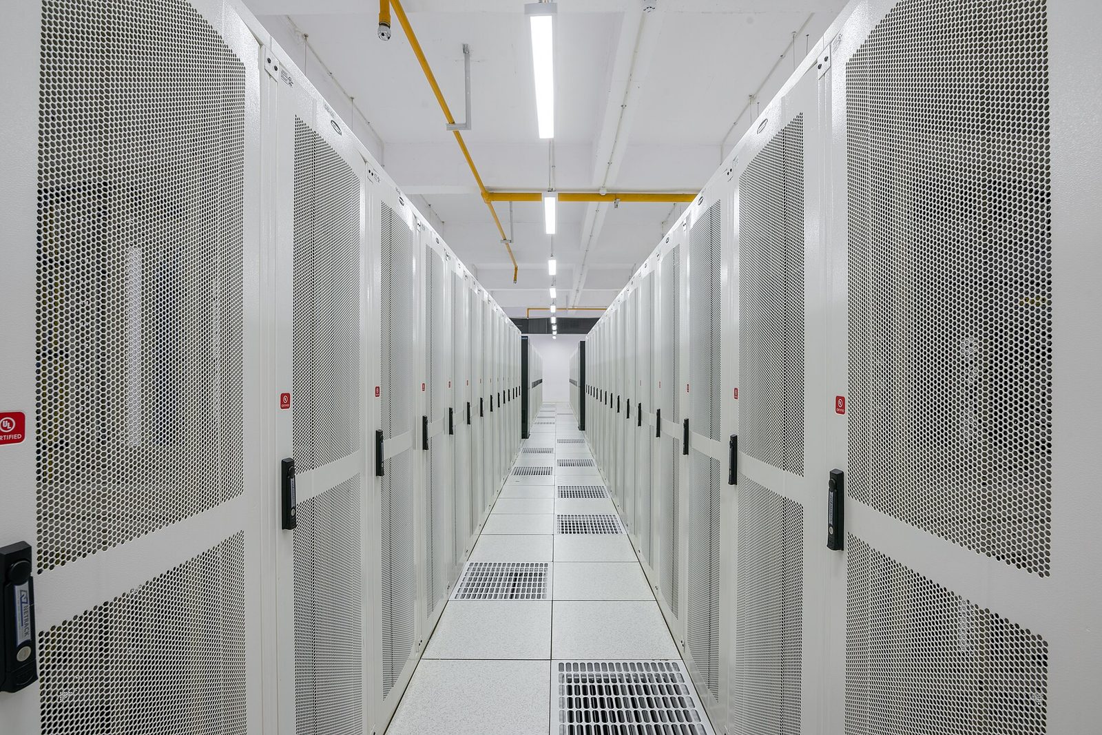Aisle of enclosed server cabinets in a data center
