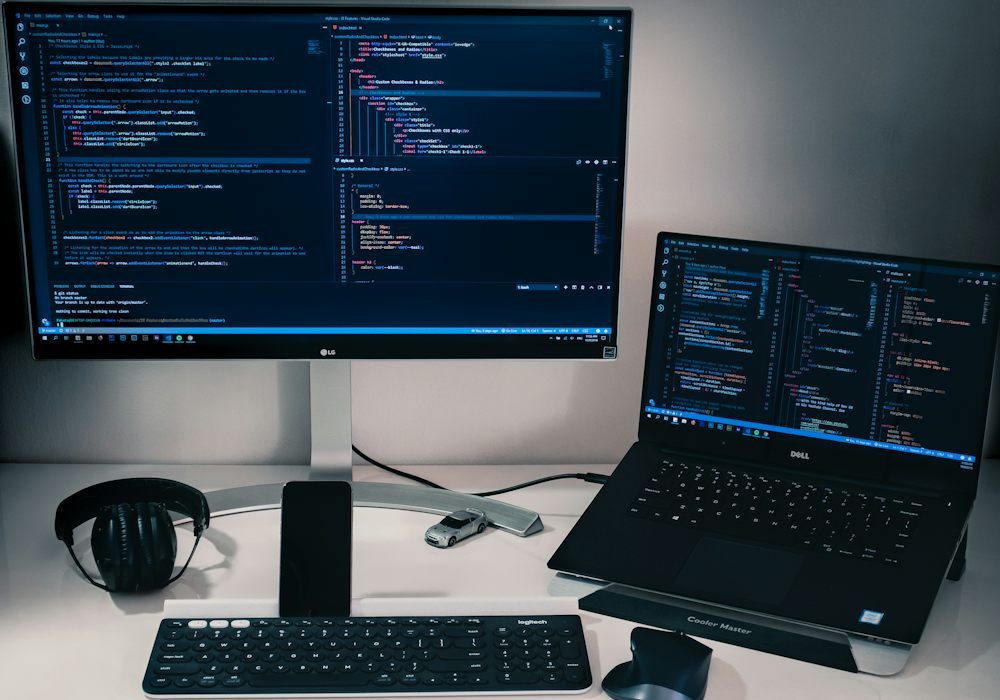 A workstation with two monitors and a laptop